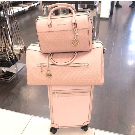 michael kors pink luggage set.jpg